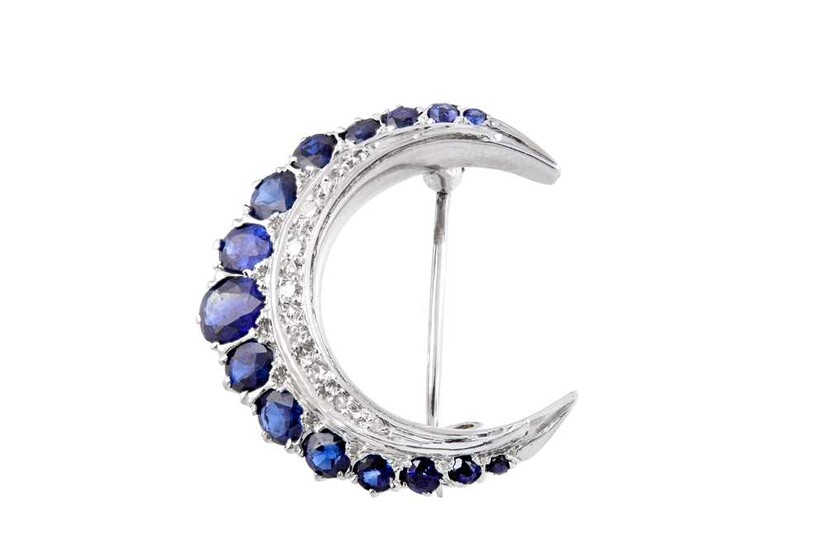 A sapphire and diamond moon crescent brooch