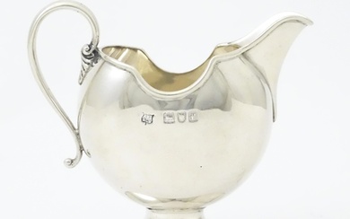 A silver cream jug hallmarked London 1901 maker S W Smith & ...