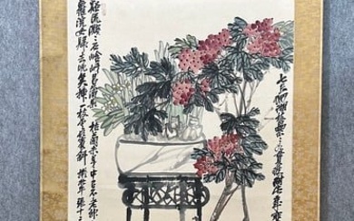 A vertical scroll of Chinese ink flower paintings by Wu Changshuo