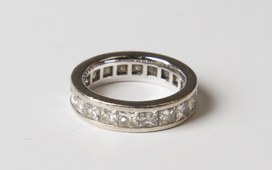 A white gold and diamond full eternity ring, mounted with princess cut diamonds, weight 6.3g, ring s