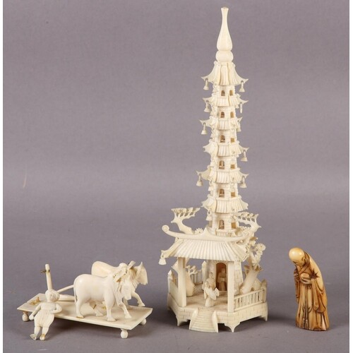 AN IVORY TEMPLE TOWER set on a hexagonal base fitted with fi...