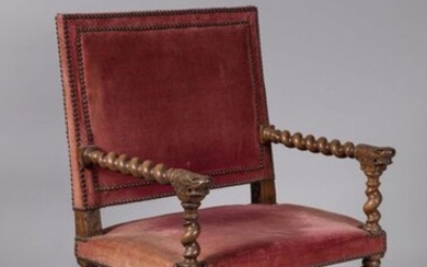 ARMCHAIR CHAIR with LION MUFLES in turned walnut. The straight back is joined by torsos arms, finished with lion mittens. The armrest supports and the base joined by an "H" spacer are also torsos, assembled by square-section connecting thimbles...