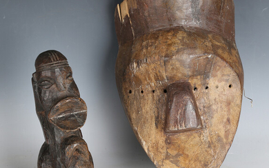 An African carved dense hardwood figure of stylized form, height 26cm, together with an African carv