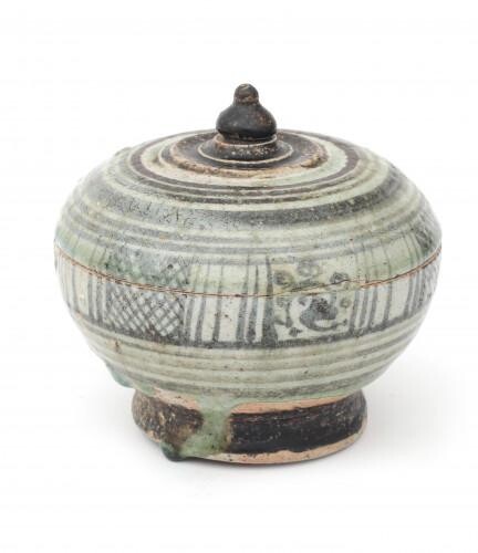 An earthenware, Iron-glazed Sawankhalok lidded bowl decorated with criss cross and florals and circled stripes to top, Thailand, 15th/16th century.