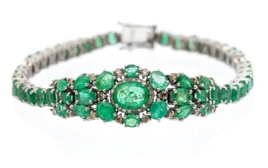 An emerald and diamond set silver bracelet set with oval...
