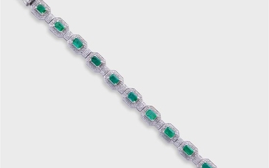 An emerald, diamond, and fourteen karat white gold strap...