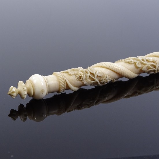 An unusual 19th century ivory rod with relief carved continu...