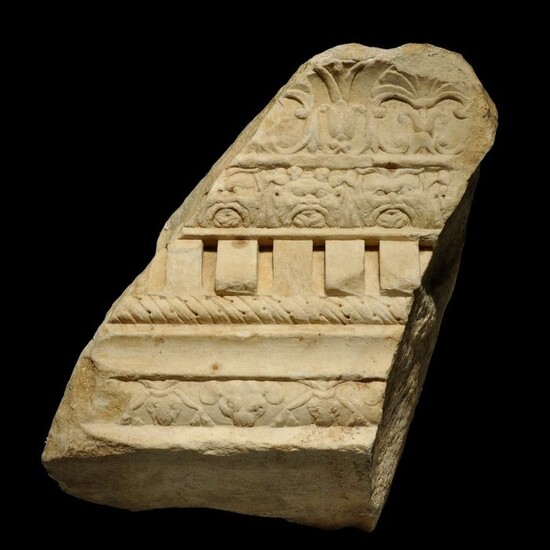 Ancient Roman Marble Architectural fragment of a Cornice with floral and faces of god Bes + mouses deco. H: 31 cm. Nice.