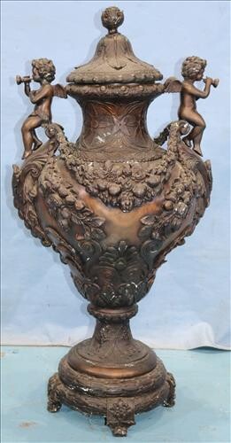 Bronze capped urn with cupids blowing trumpets
