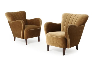 Danish furniture design A pair of easy chairs with stained beech legs,...