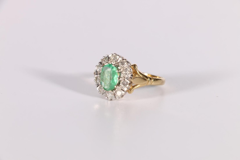 Diamond and emerald oval cluster ring in 18ct gold, 1975. Si...