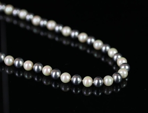 Dior simulated grey and white pearl necklace on white