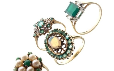 Four 9ct gold dress rings, each set green stones,...