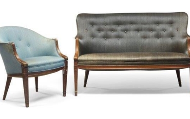Frits Henningsen (Danish 1889-1965), a two seater settee and matching armchair, c.1940, With shaped button back, upholstered in charcoal fabric, with carved reeded and scrolling armrests on square tapering legs, the matching chair with blue fabric...