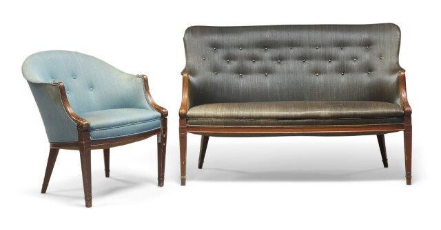Frits Henningsen (Danish 1889-1965), a two seater settee and matching armchair, c.1940, With shaped button back, upholstered in charcoal fabric, with carved reeded and scrolling armrests on square tapering legs, the matching chair with blue fabric...