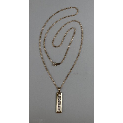 Gold 7 stone diamond pendant on a gold rope chain