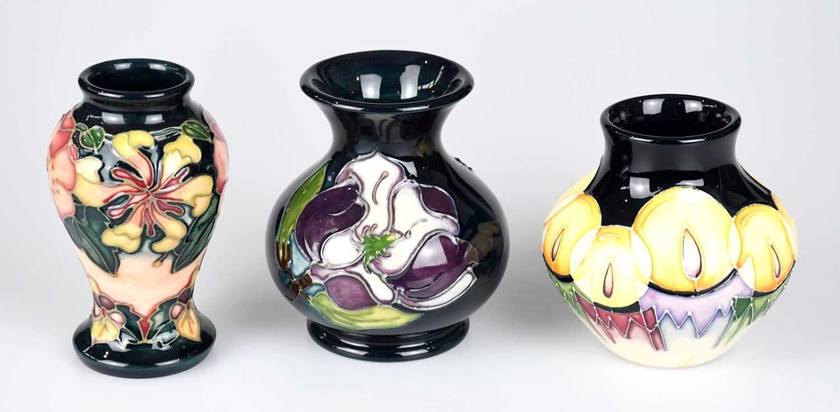 MOORCROFT; three small vases, including an example decorated in the...