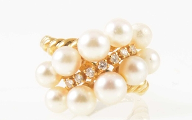 Mikimoto - an 18 carat yellow gold dress ring set with seven graduated small diamond and pearls.