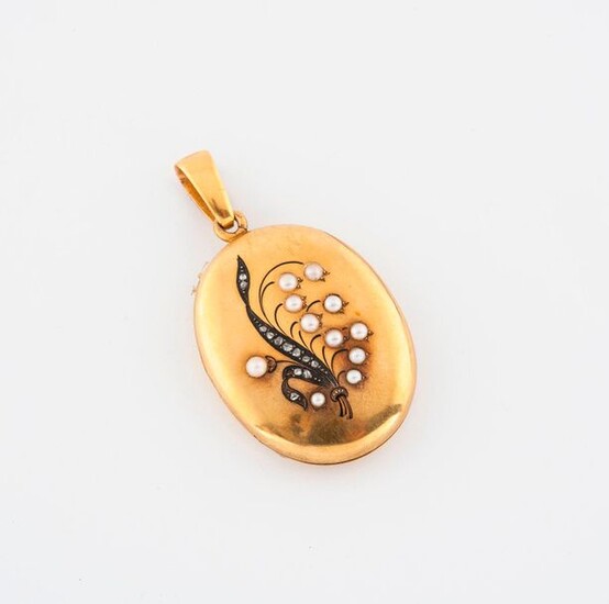 Oval yellow gold (750) photo pendant with a strand of lily of the valley.
