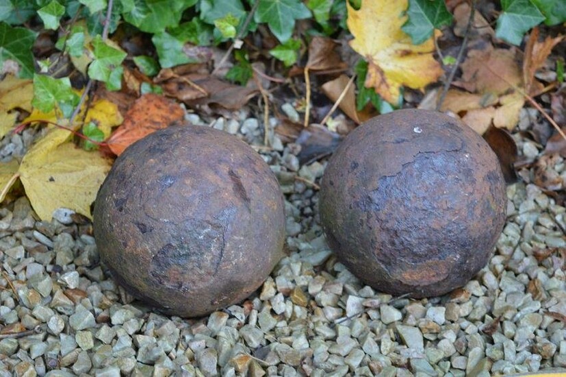 TWO EARLY CAST IRON CANON BALLS