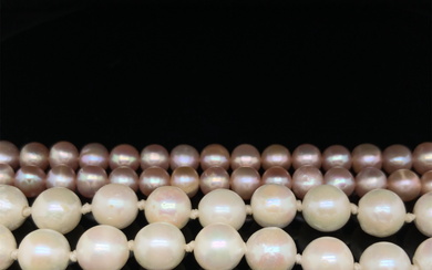 TWO STRINGS OF CULTURED PEARLS. A PINK 82cm ROPE WITH A 9ct HALLMARKED GOLD CLASP, AND A FURTHER