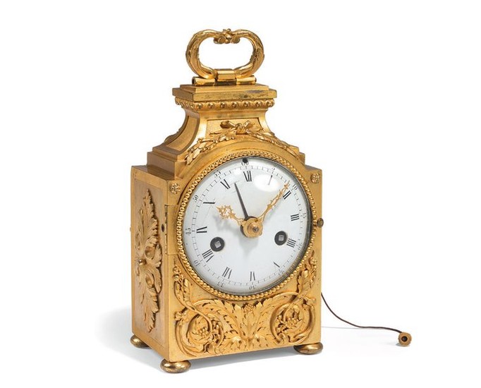 Table clock in gilded bronze, the white enamelled...