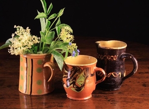Three Decorative 19th Century French Slipware Jugs with yellow glazed interiors: One with marbled ag