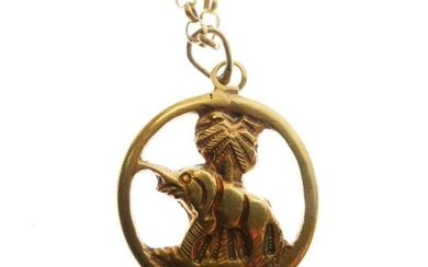 Unmarked yellow metal pendant, cast as an elephant standing...