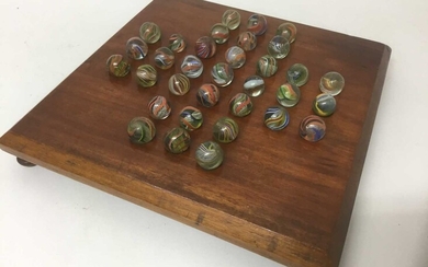 Victorian solitaire board and marbles.