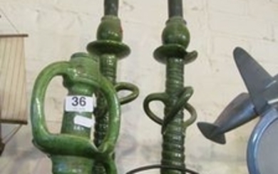 A pair of Arts & Crafts green pottery candlesticks with twist stems and another smaller.