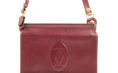 CARTIER - a reversible Must De Cartier Bordeaux messenger handbag. View more details