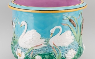 GEORGE JONES MAJOLICA JARDINIÈRE Decorated with swans, water lilies and pond reeds against a turquoise-colored ground. Pink interior...