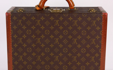 Louis Vuitton Paris Coteville hard shell suitcase, with the classic brown and gold "LV" monogram pattern, leather trim further stamp...