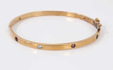 9ct gold hinged bangle set with eight multi coloured sapphires