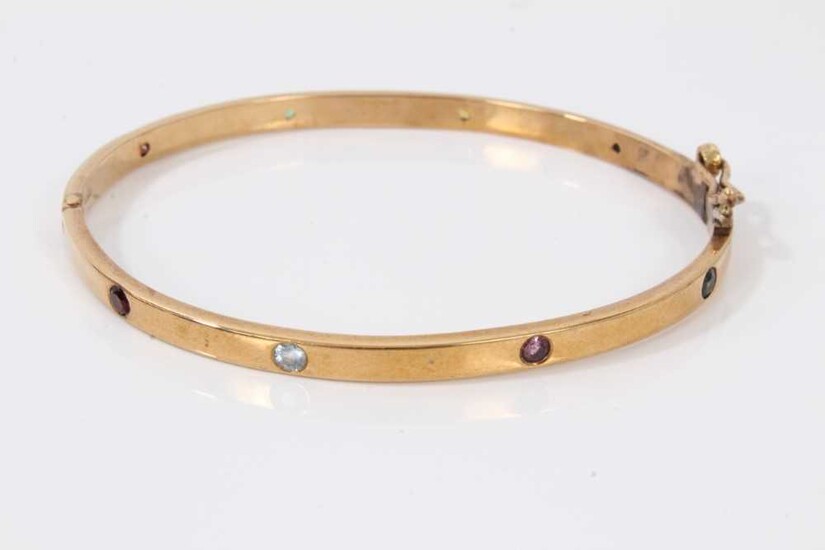 9ct gold hinged bangle set with eight multi coloured sapphires