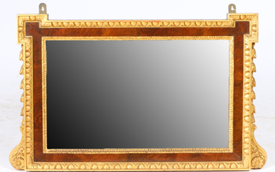 A 19TH CENTURY WALNUT AND GILDED WALL MIRROR.