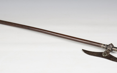 A 19th century Middle Eastern steel headed and white metal mounted battle axe, mounted on a hardwood