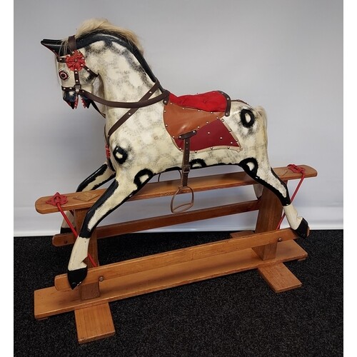 A 19th century wood and hand painted rocking horse, fitted w...