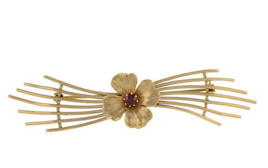 A 9ct gold garnet stylised flower brooch.