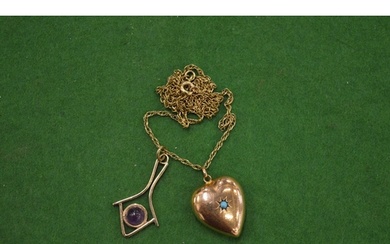 A 9ct gold heart shaped locket inset with a turquoise caboch...