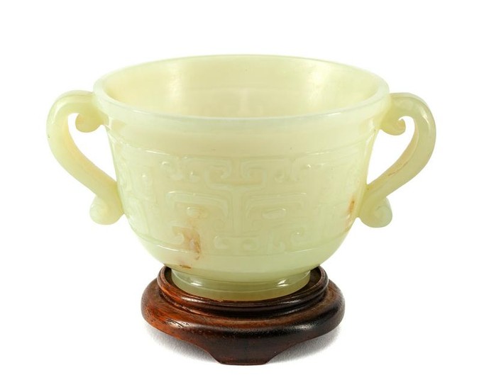 A Chinese Carved Jadeite Cup on a Wood Base