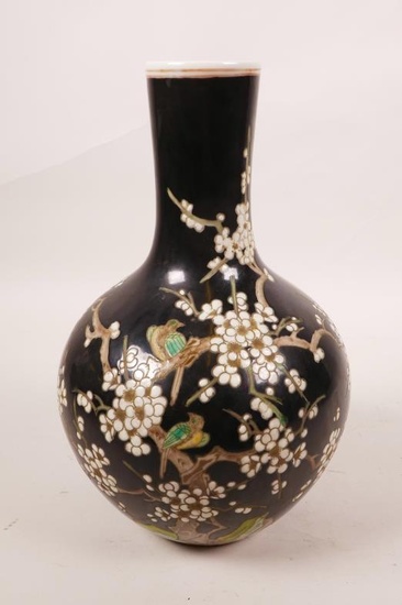 A Chinese famille noire porcelain vase decorated with birds...