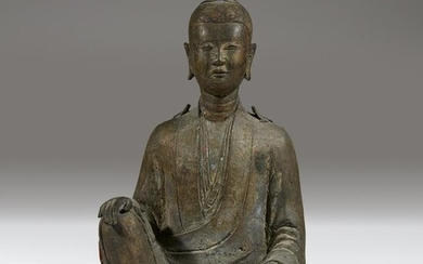 A Chinese or Southeast Asian bronze figure of a seated