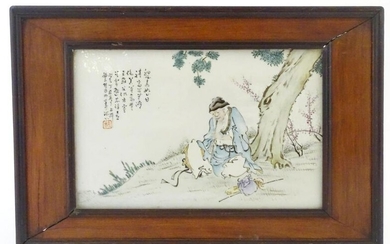 A Chinese porcelain plaque decorated with a seated