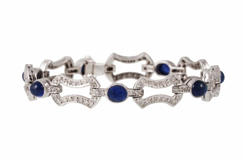 A DIAMOND AND SAPPHIRE BRACELET, the cabachon sapphires to d...