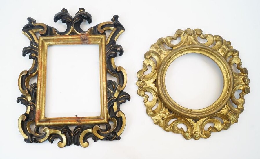A Florentine style carved wood frame, late 19th century, with gilt and ebonised pierced and scrolling decoration, 41cm high, 30.3cm wide; together with a circular giltwood frame with pierced and scrolling foliate decoration, 32cm diameter (2)