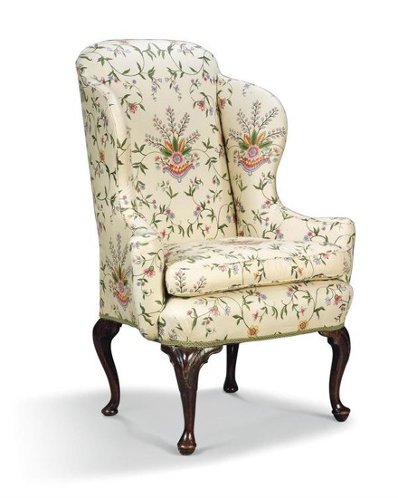 A George II style mahogany and walnut wing armchair