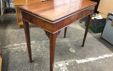 A Georgian mahogany fold-over card table with moulded rectangular top...