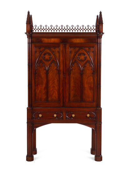 A Gothic Style Carved Mahogany Cabinet with P.E. Guerin Hardware