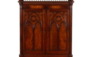 A Gothic Style Carved Mahogany Cabinet with P.E. Guerin